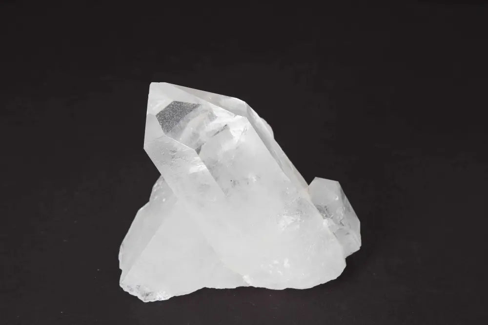 Clear Quartz Cluster on black background showcasing natural crystal points and clarity.