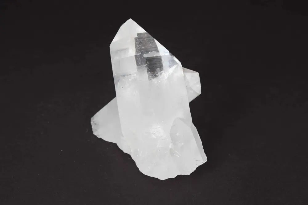 Clear Quartz Cluster on dark background displaying natural crystal formations