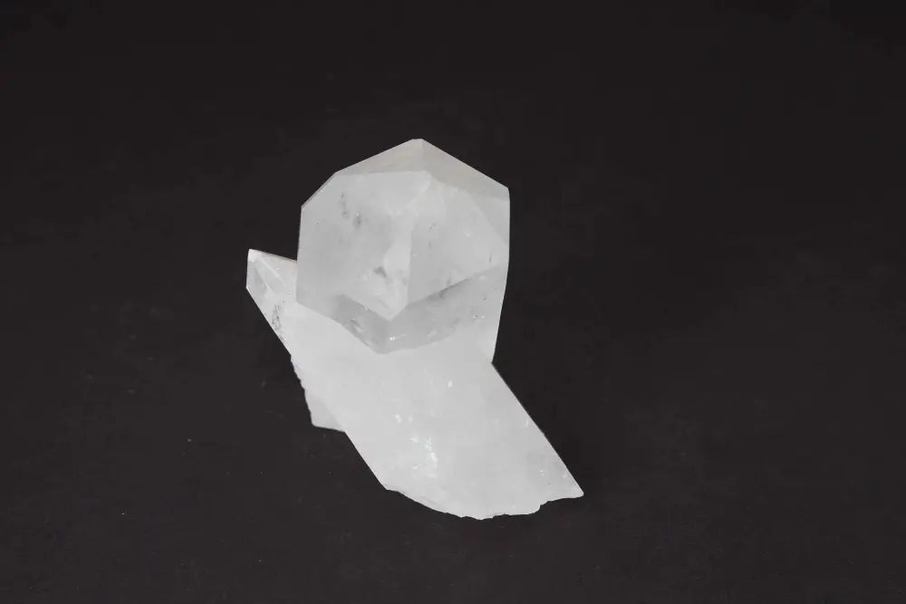 Clear Quartz Cluster on black background, radiating pure energy and high vibrational light, perfect for amplifying intention and purifying space.