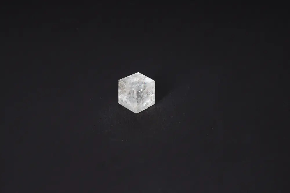 Clear Quartz Cube 2.5 cm on black background, a stone known for purification, harmonizing energy, and neutralizing negative vibrations.