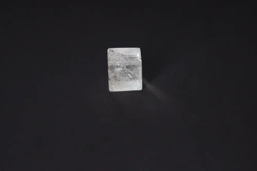 Clear Quartz Cube 3.5 cm on dark background, stone of purification and harmonization, absorbs negative energy, cleanses electromagnetic radiation.