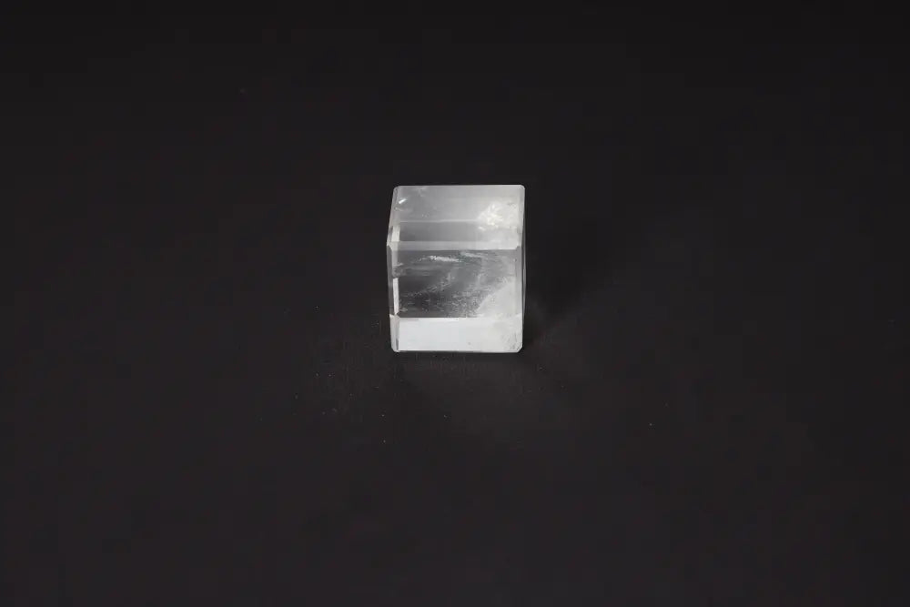 Clear Quartz Cube 4 cm on black background, stone for purification, harmonizes energy, absorbs negative vibrations, cleanses spaces.