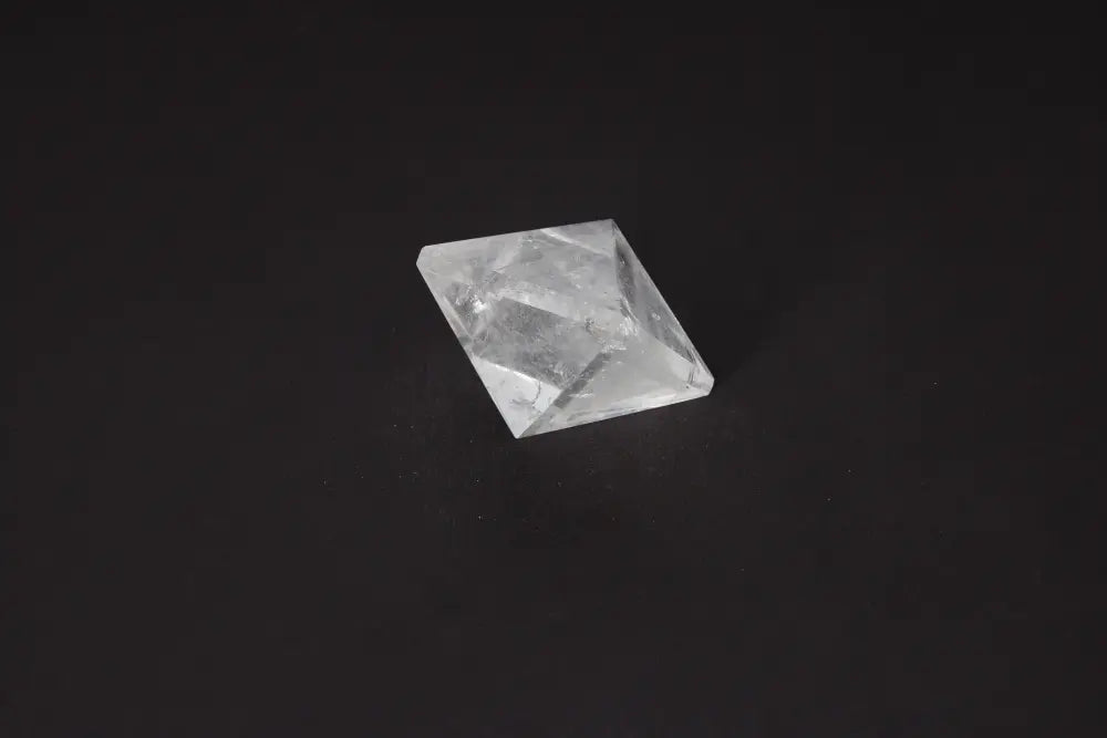 Clear Quartz Double Pyramid 4 cm stone on dark background; ideal for purification and absorbing negative vibrations.