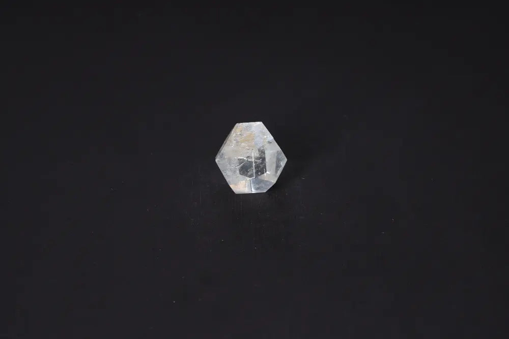 Clear Quartz Geometric Sphere 3 cm, a stone of purification and energy harmony, against a black background.