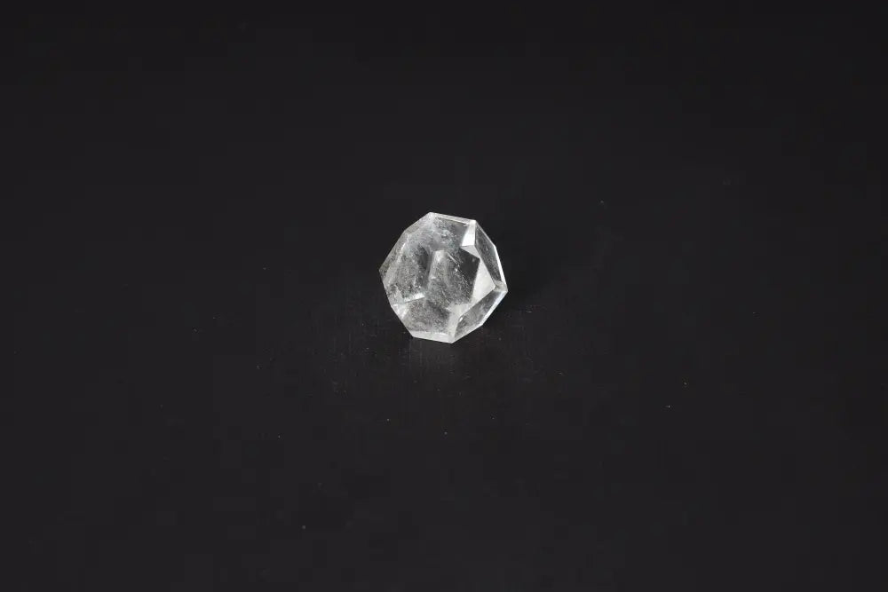 Clear Quartz Geometric Sphere 3 cm on black background, stone for purification and neutralizing negative energy and radiation.