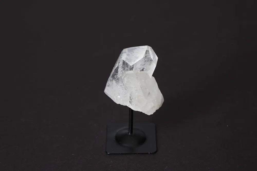 Clear Quartz on metal stand, elegant crystal from Sylvia Crystals, enhances clarity and amplifies energy, spiritual harmony display.