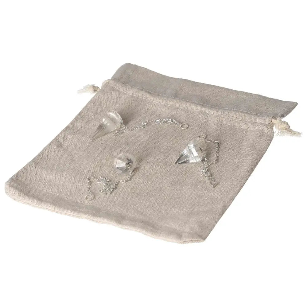 Clear Quartz Pendulum for energy purification and negative vibration neutralization on a soft cloth bag.