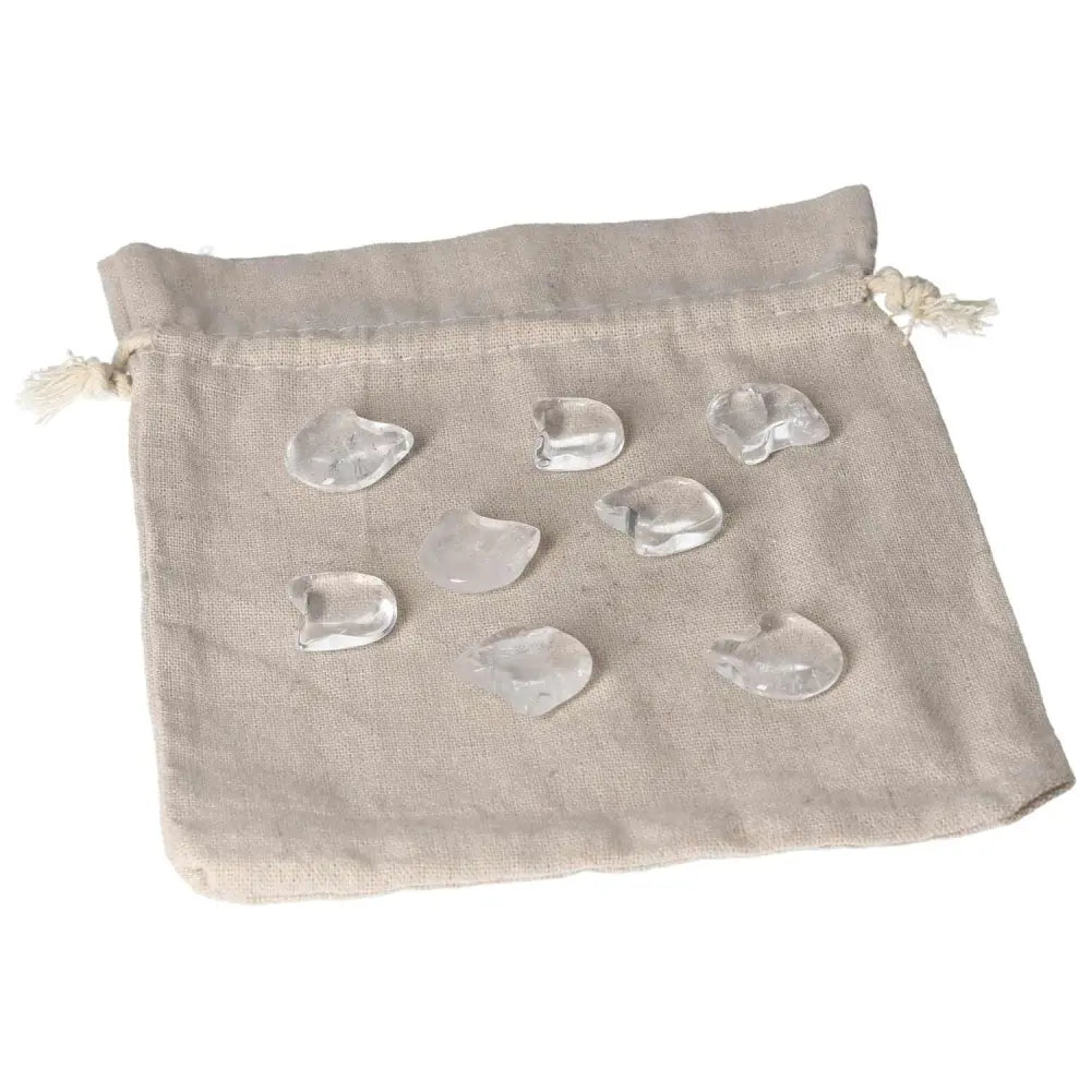 Clear Quartz small cat figures on a beige pouch, symbolizing clarity, protection, and playful energy for collectors and spiritual seekers.