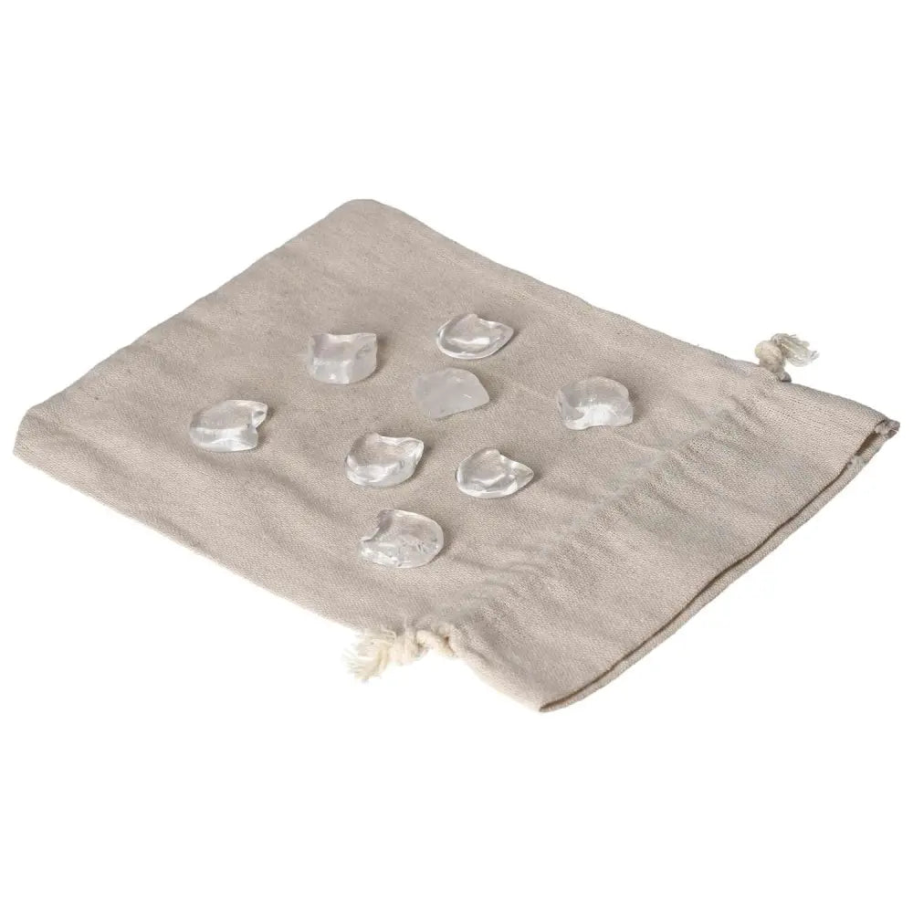 Clear Quartz small cat figures on a beige cloth, symbolizing clarity, intuition, and playful energy in a serene display.