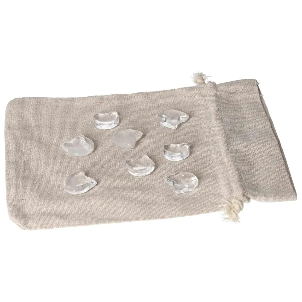 Clear Quartz small cat figures on beige cloth, promoting clarity, protection, and playful energy in spiritual practices.