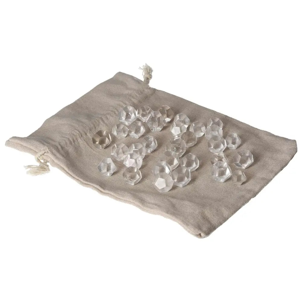 Clear Quartz geometric spheres on a beige fabric pouch for purification and harmonizing energy.