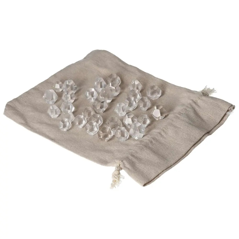 Clear quartz geometric spheres on beige cloth bag, ideal for purification and harmonizing energy.