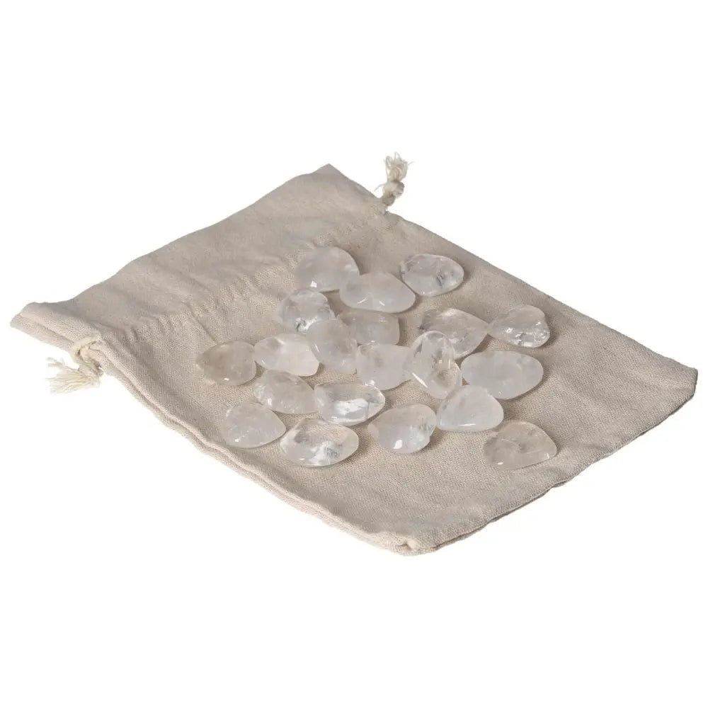 Clear Quartz small heart stones on fabric pouch, ideal for purification, harmonizing energy, and neutralizing negative vibrations.