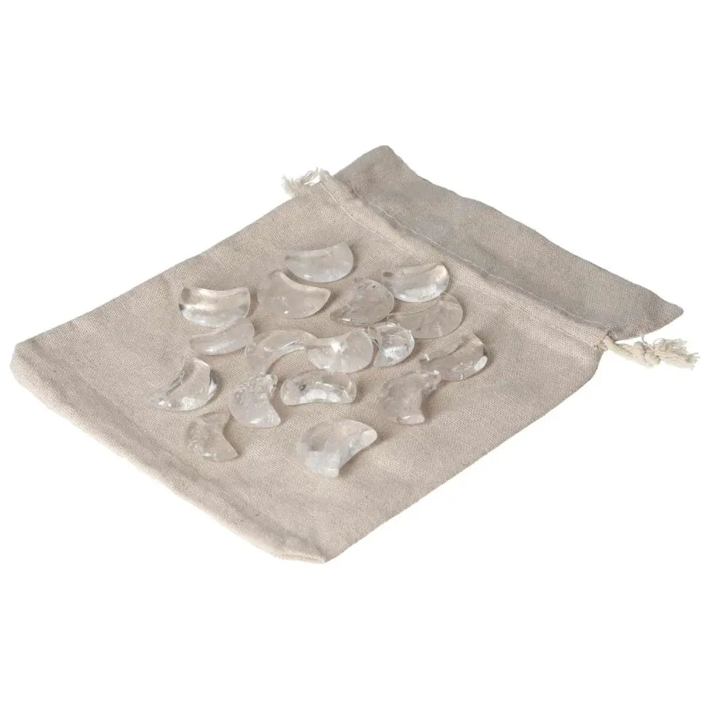 Small clear quartz moon stones on a beige pouch, known for harmonizing energy and neutralizing negative vibes.