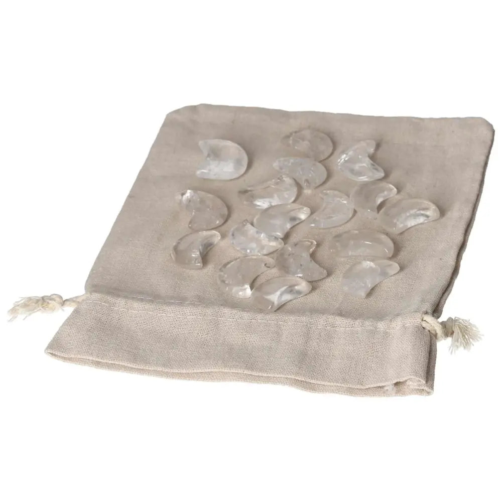 Clear Quartz small moon stones on linen pouch, ideal for energy purification and electromagnetic radiation neutralization.