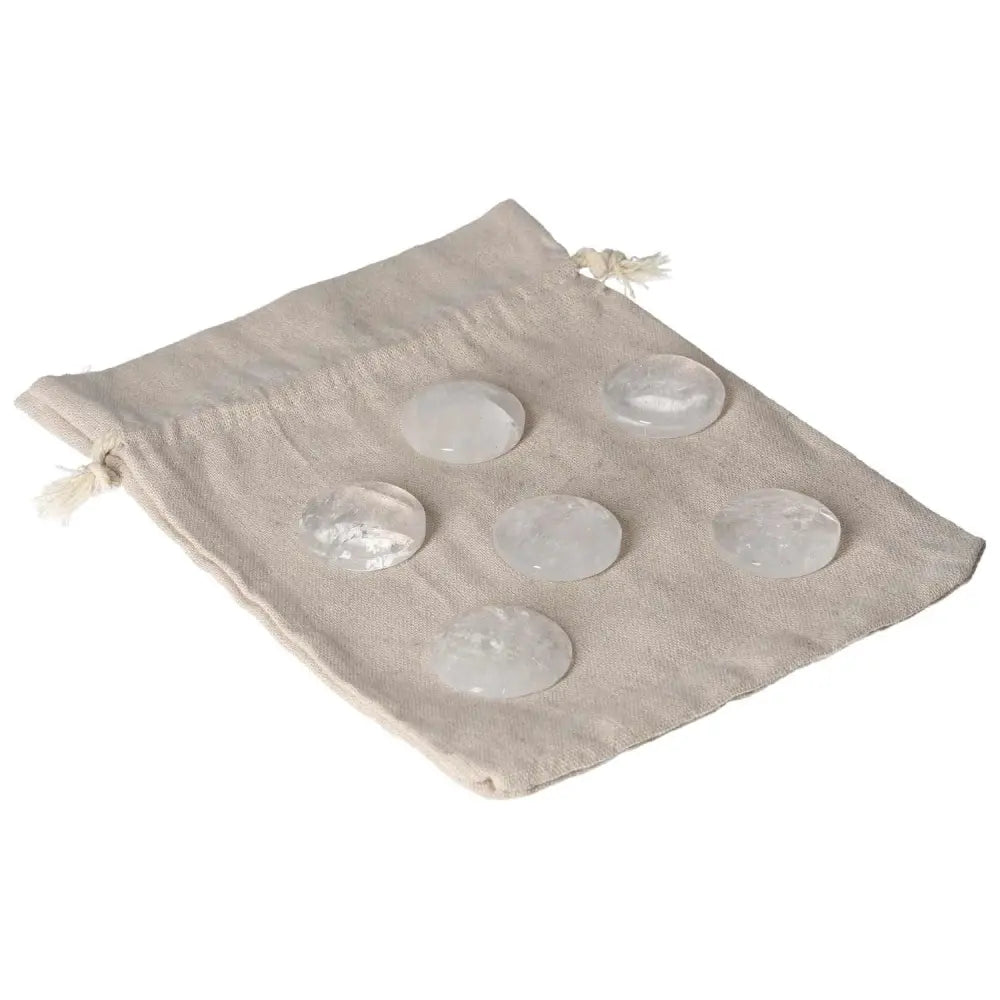 Set of six Clear Quartz small palmstones on a beige drawstring bag for cleansing and harmonizing energy