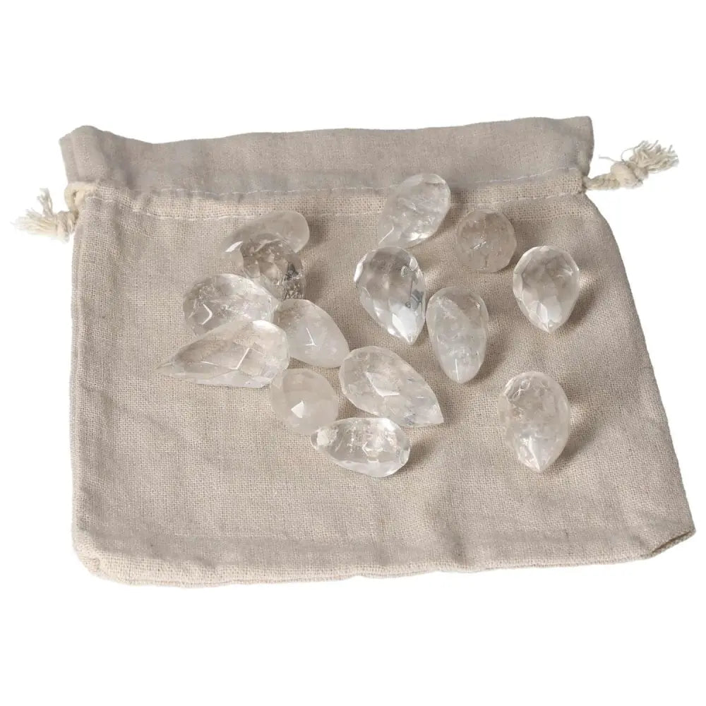 Clear Quartz small tear stones on a beige cloth bag for purification and energy harmonization, ideal for neutralizing negative vibrations.