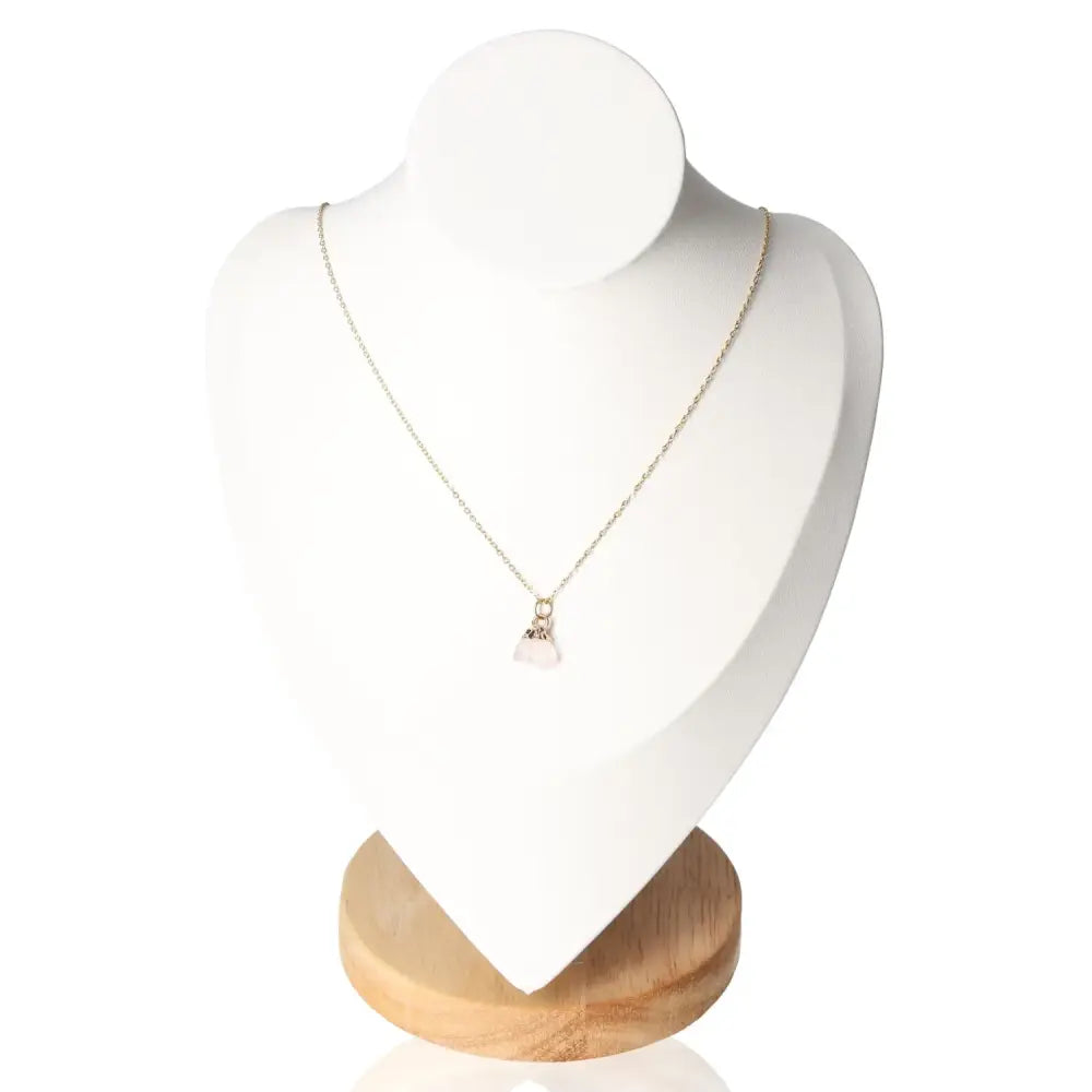 Crystal Necklace Set "Love" featuring Rose Quartz pendant, symbolizing love and harmony, displayed on wooden stand.
