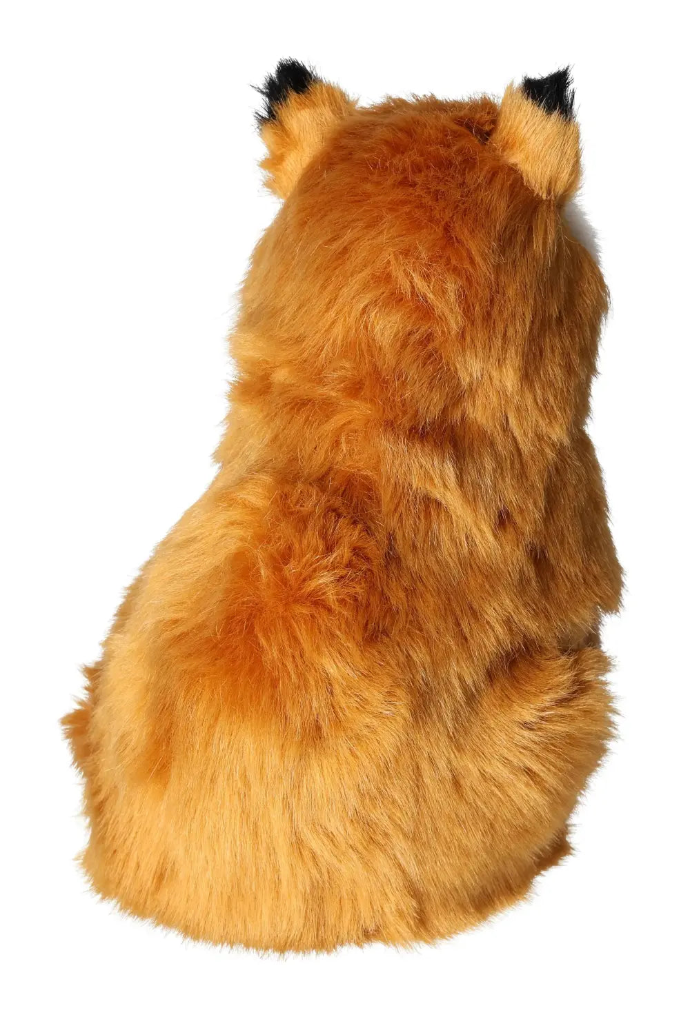 Back view of a plush fox toy with soft orange fur and black-tipped ears.