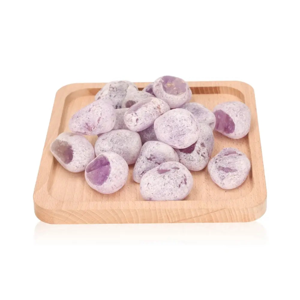 Emma Eggs on a wooden tray, smooth oval stones in soft purple hues, naturally polished for harmony and grounding.