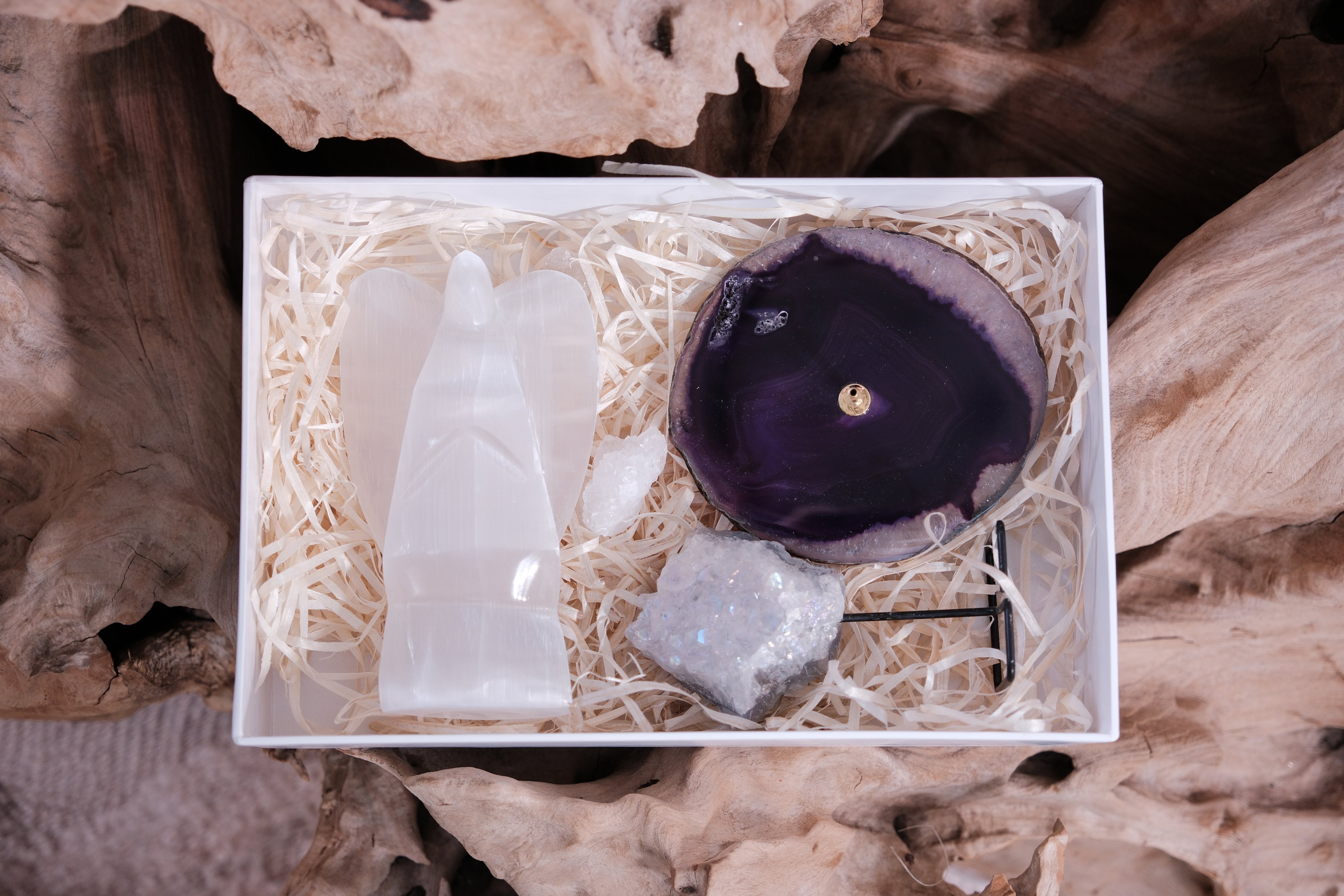 Sylvia Crystals Christmas Box with hand-selected crystals for peace, featuring a selenite angel, agate candle holder, and shimmering crystal.