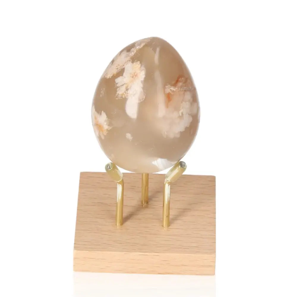 Flower Agate Egg on stand, symbolizing growth and healing, with delicate blossom patterns for inner peace and positive energy.