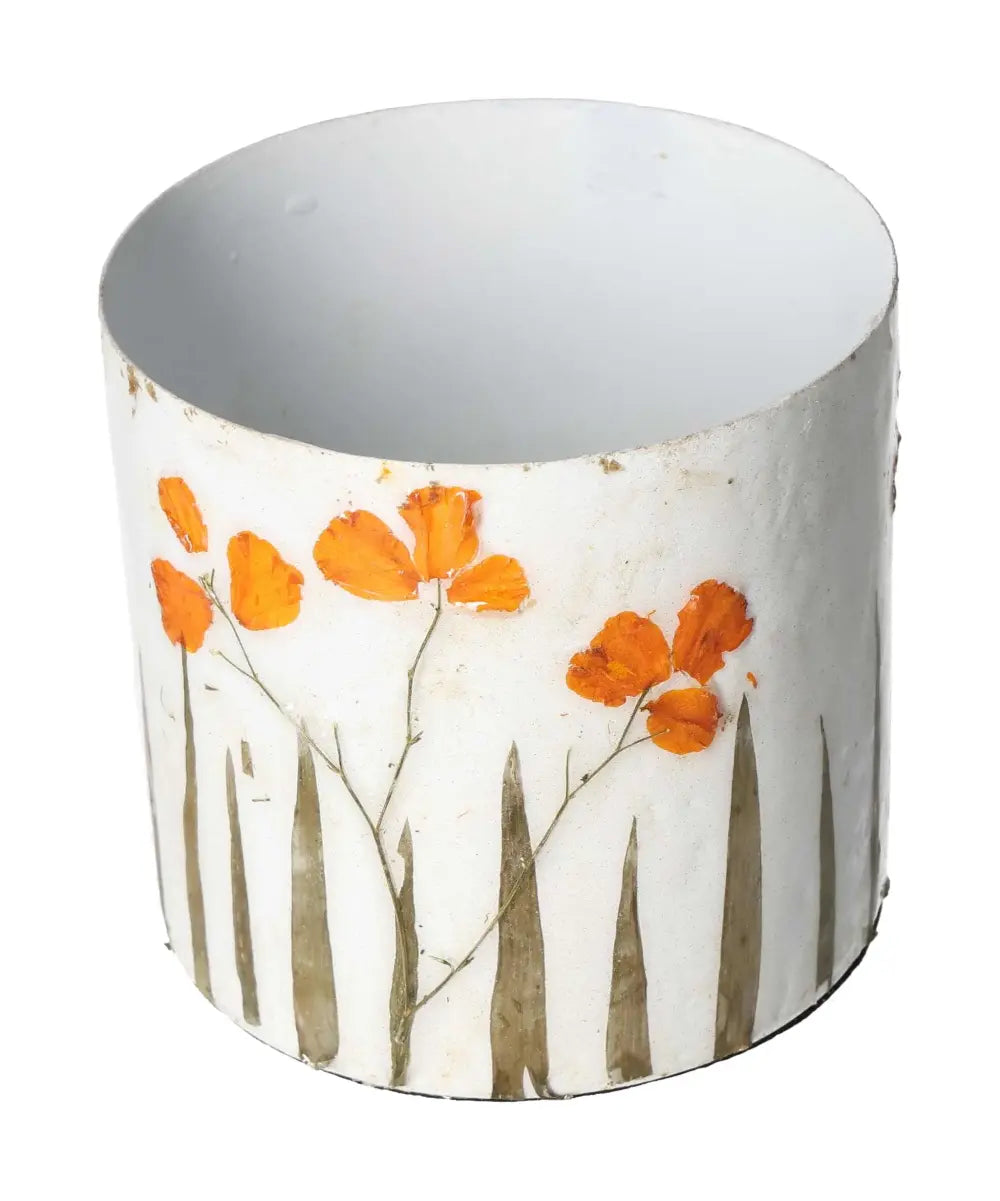 White planter adorned with orange flower motif, 11x11x10 inches, designed by Sylvia Crystals, blending luxury with conscious living.