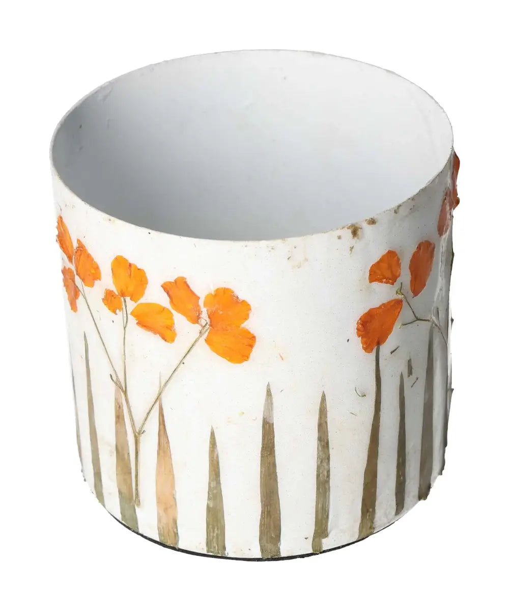 Elegant planter with orange flower motifs on a cylindrical white surface, displaying fine craftsmanship and artistic simplicity.