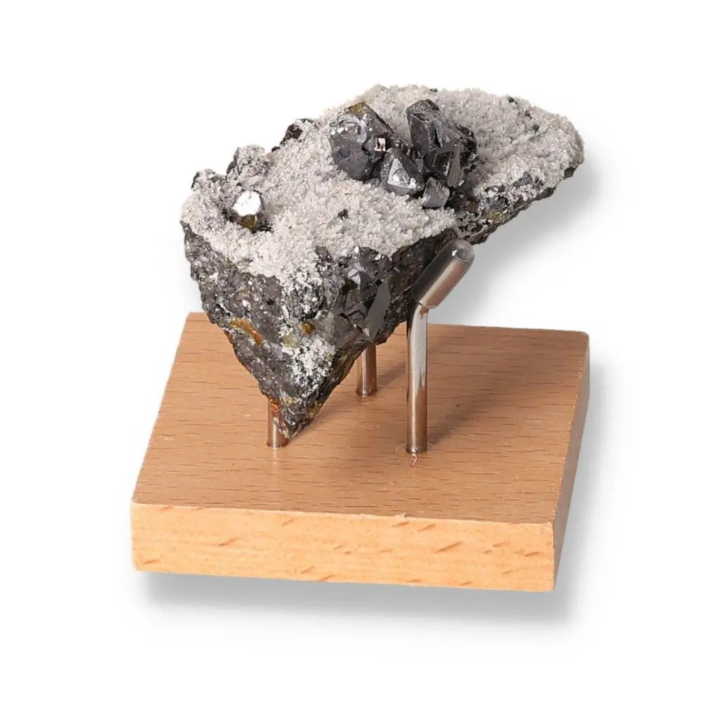 Galena stone display on wooden stand, showcasing its protective and grounding properties for spiritual harmony and transformation.