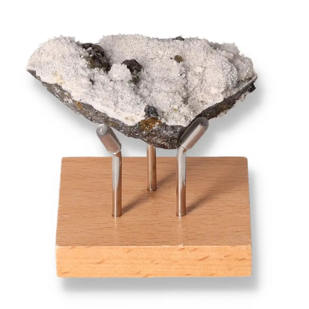 Galena mineral specimen on a wooden display stand, showcasing its transformative properties and esoteric allure.