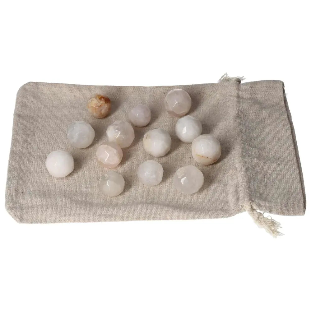 Golden Healer small geometric spheres on a beige fabric pouch, enhancing spiritual healing and energy flow.