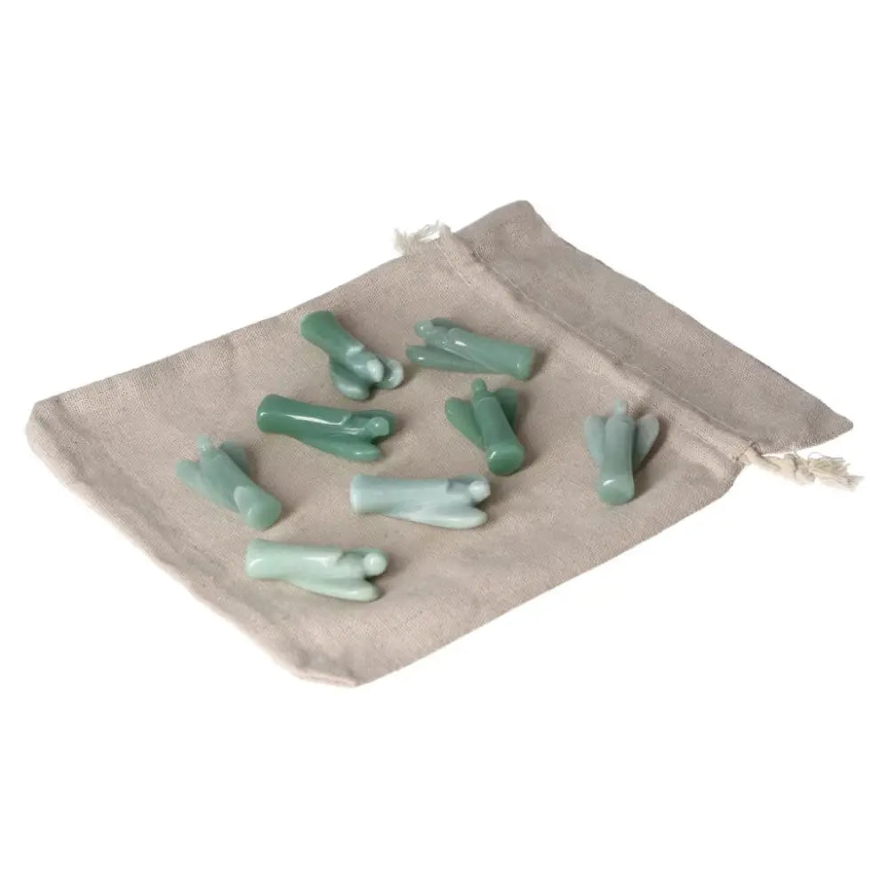 Green Aventurine Small Angel stones on a beige cloth, symbolizing self-confidence, luck, and inner peace.