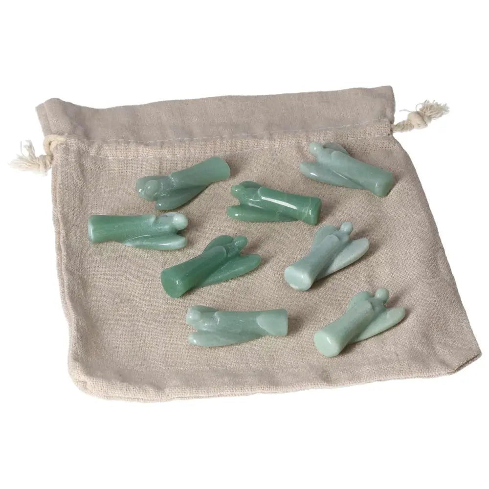 Small Green Aventurine angel figurines on a fabric pouch, symbolizing new beginnings, luck, and inner peace.
