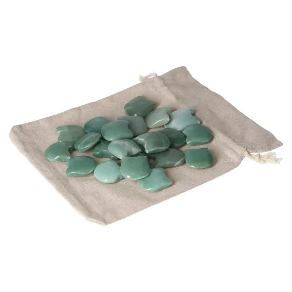 Green Aventurine stones on a beige cloth bag, symbolizing luck and prosperity, promoting new beginnings and inner harmony.