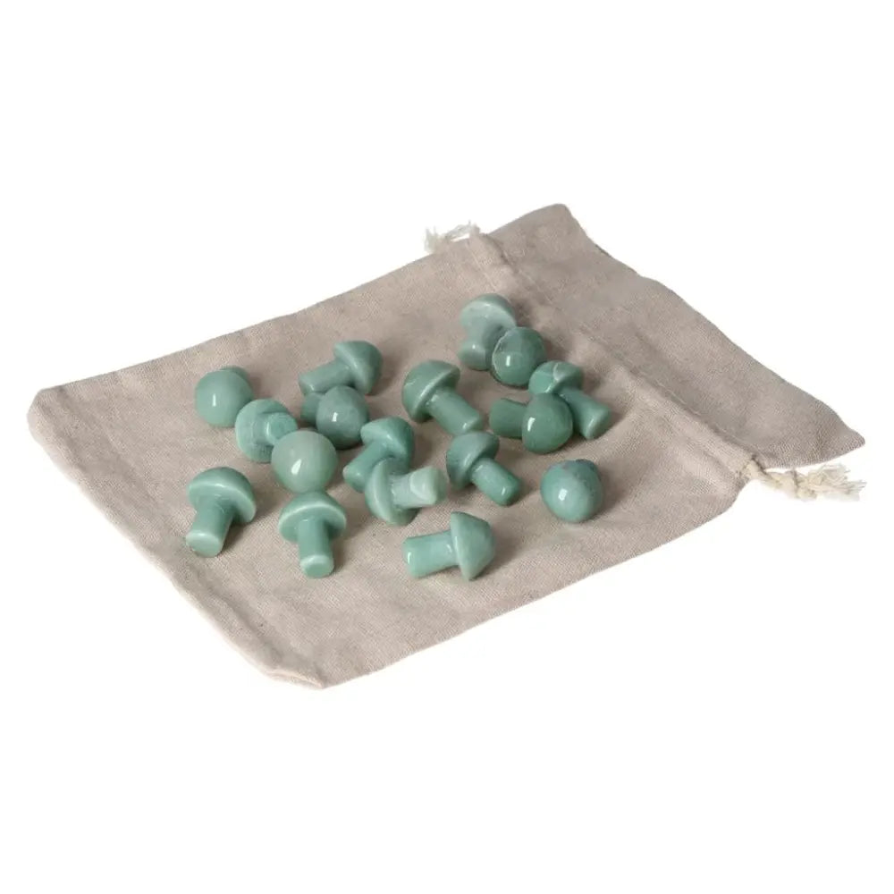 Collection of small green aventurine mushroom stones on a cloth bag, symbolizing luck, prosperity, and inner peace.
