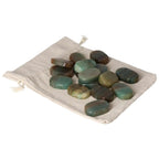 Green Quartz with Hematite thumb massagers on a beige pouch, offering stress relief and spiritual elevation from Sylvia Crystals.