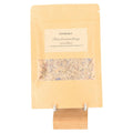 Incense Blend 'Letting go' in kraft bag with clear window on wooden stand, featuring elder bush for spiritual release.