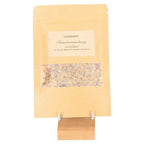 Incense Blend 'Letting go' in kraft bag with clear window on wooden stand, featuring elder bush for spiritual release.