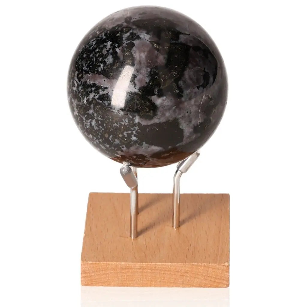 Indigo Gabbro Sphere on stand showcasing mystical black and indigo swirls, enhancing intuition and spiritual growth.