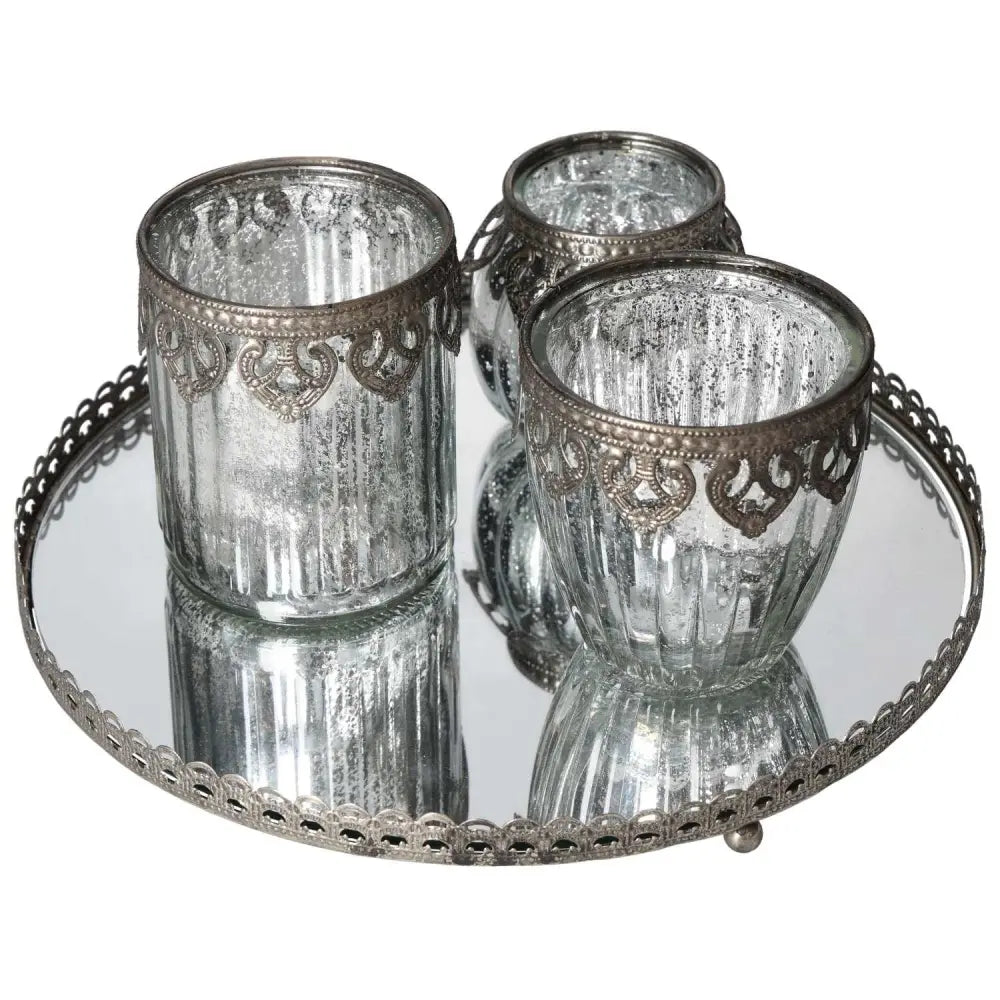 Lantern set on silver metal rim mirror tray by Sylvia Crystals, blending elegance and functionality for luxe home decor.