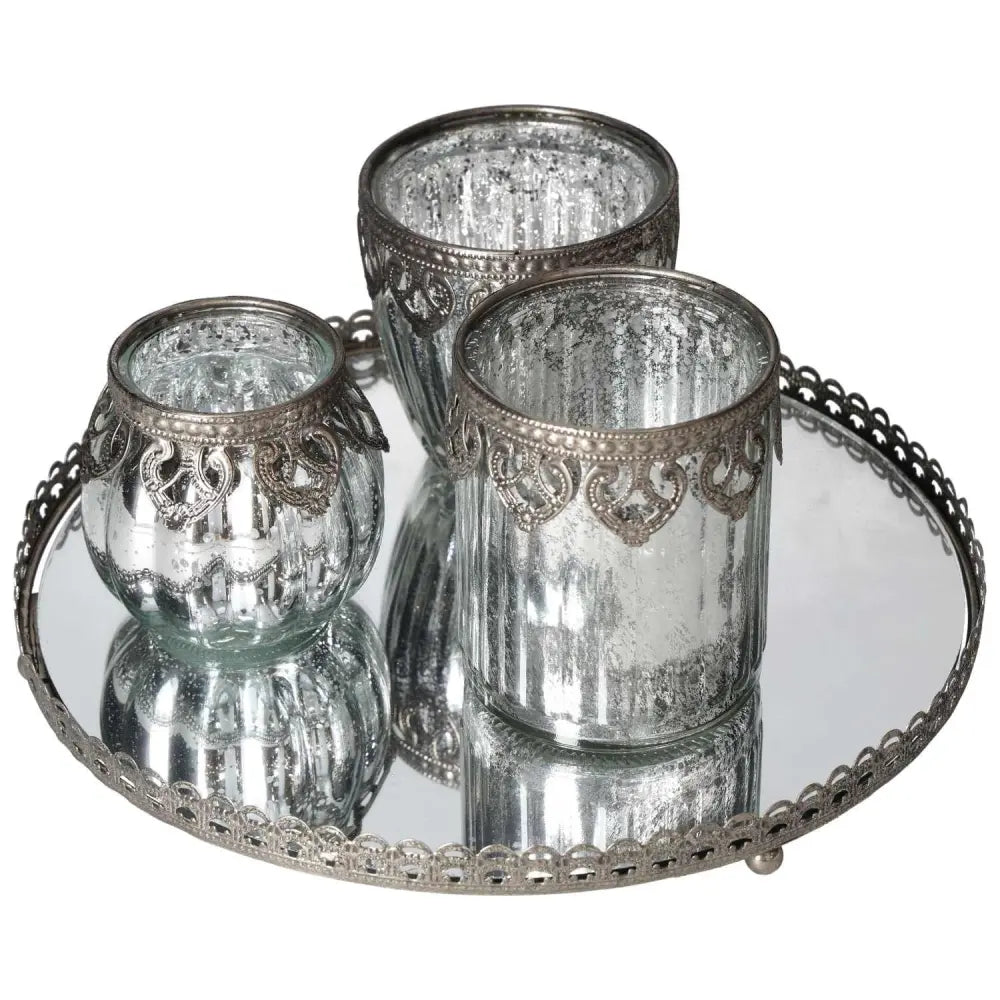 Elegant lantern set on mirror tray with silver metal rim, perfect for adding luxury and sophistication to any space by Sylvia Crystals.