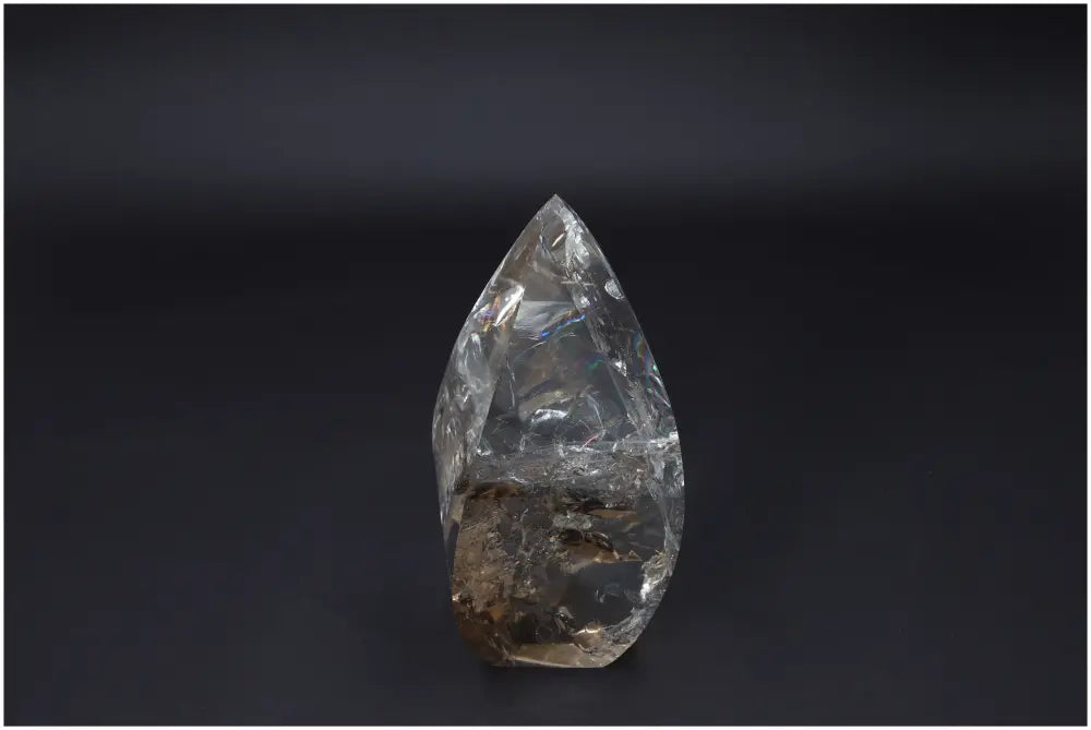 Large Lemurian Quartz Obelisk on dark background, highlighting its clear, natural crystalline structure and ethereal beauty.