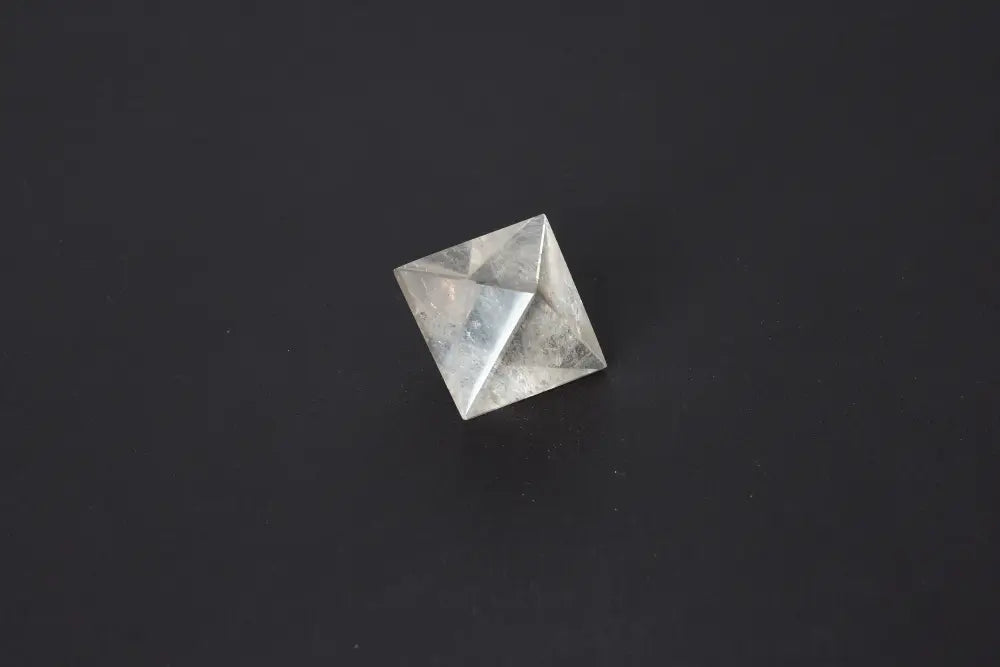 Lemurian Quartz Double Pyramid 3 cm displaying sacred geometry against a dark background, highlighting its ethereal clarity and striations.