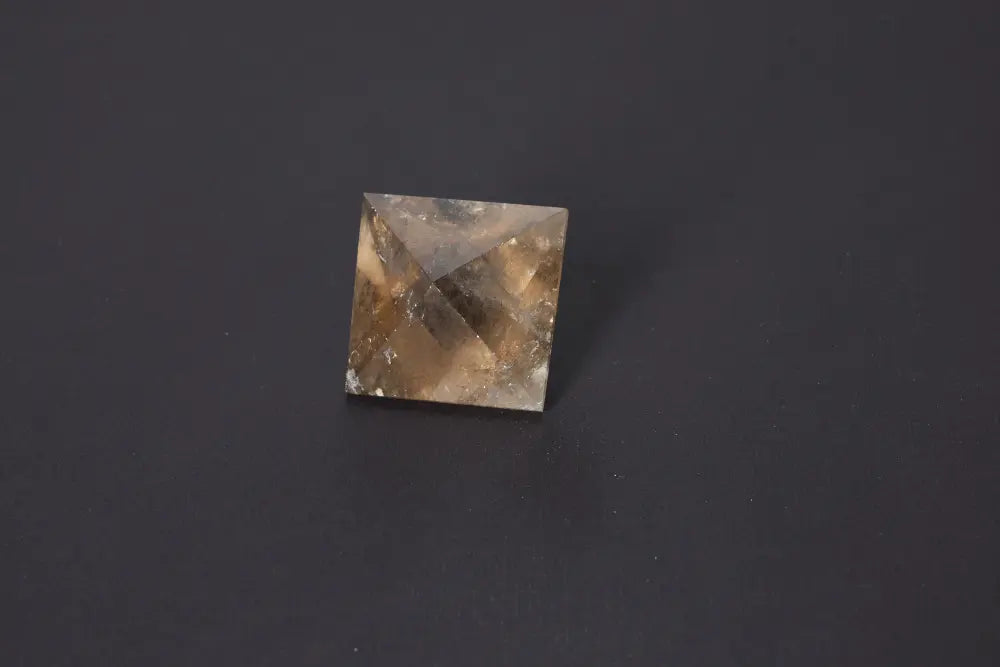 Lemurian Quartz double pyramid on dark background, showcasing its sacred geometry and ancient wisdom properties.