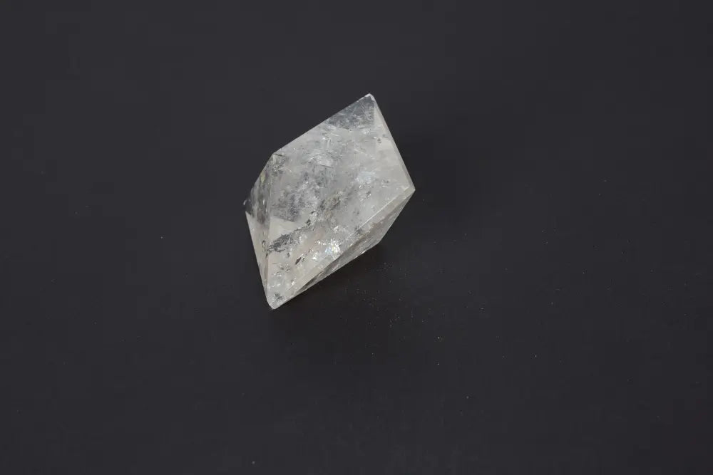 Lemurian Quartz Double Pyramid 5 cm featuring sacred geometry and ancient wisdom on a dark background.