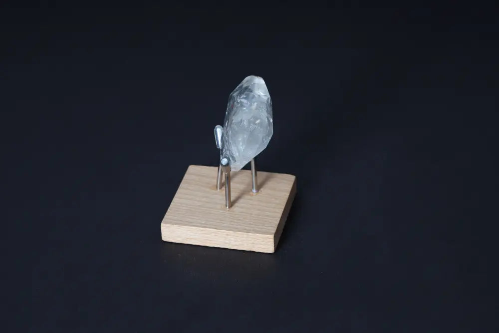Lemurian Quartz Geometric Heart on wooden stand featuring a modern design and spiritual essence