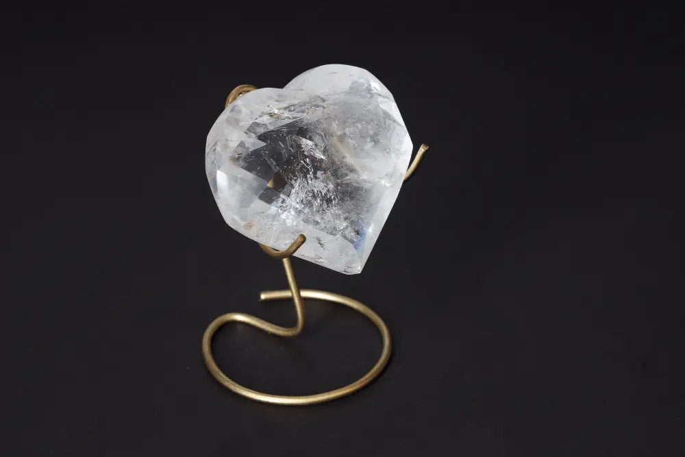 Lemurian Quartz Geometric Heart crystal on a stand, showcasing its clarity and elegant heart shape, perfect for spiritual harmony.