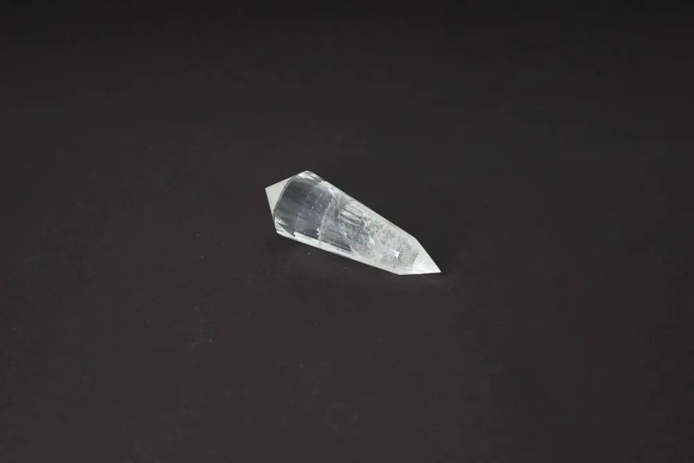 Lemurian Quartz Point crystal against a dark background, showcasing distinct striations, thought to hold ancient Lemurian wisdom.