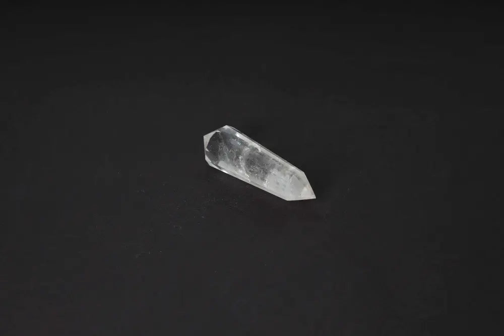 Lemurian Quartz Point crystal with distinctive striations symbolizing ancient wisdom on a dark background.