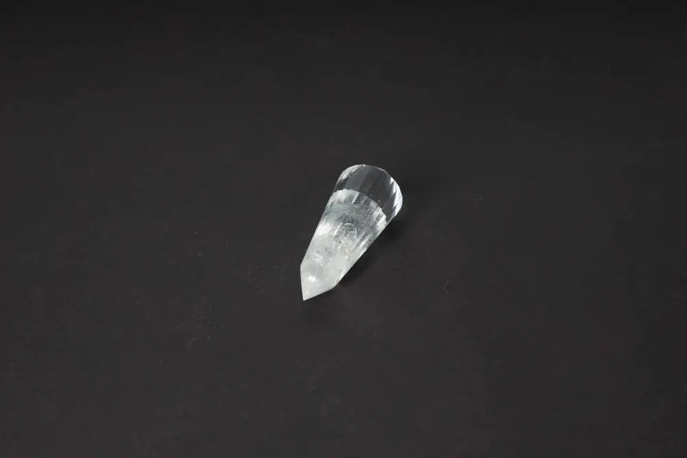 Lemurian Quartz Point with distinct horizontal striations on a dark background, symbolizing ancient wisdom and spiritual harmony.